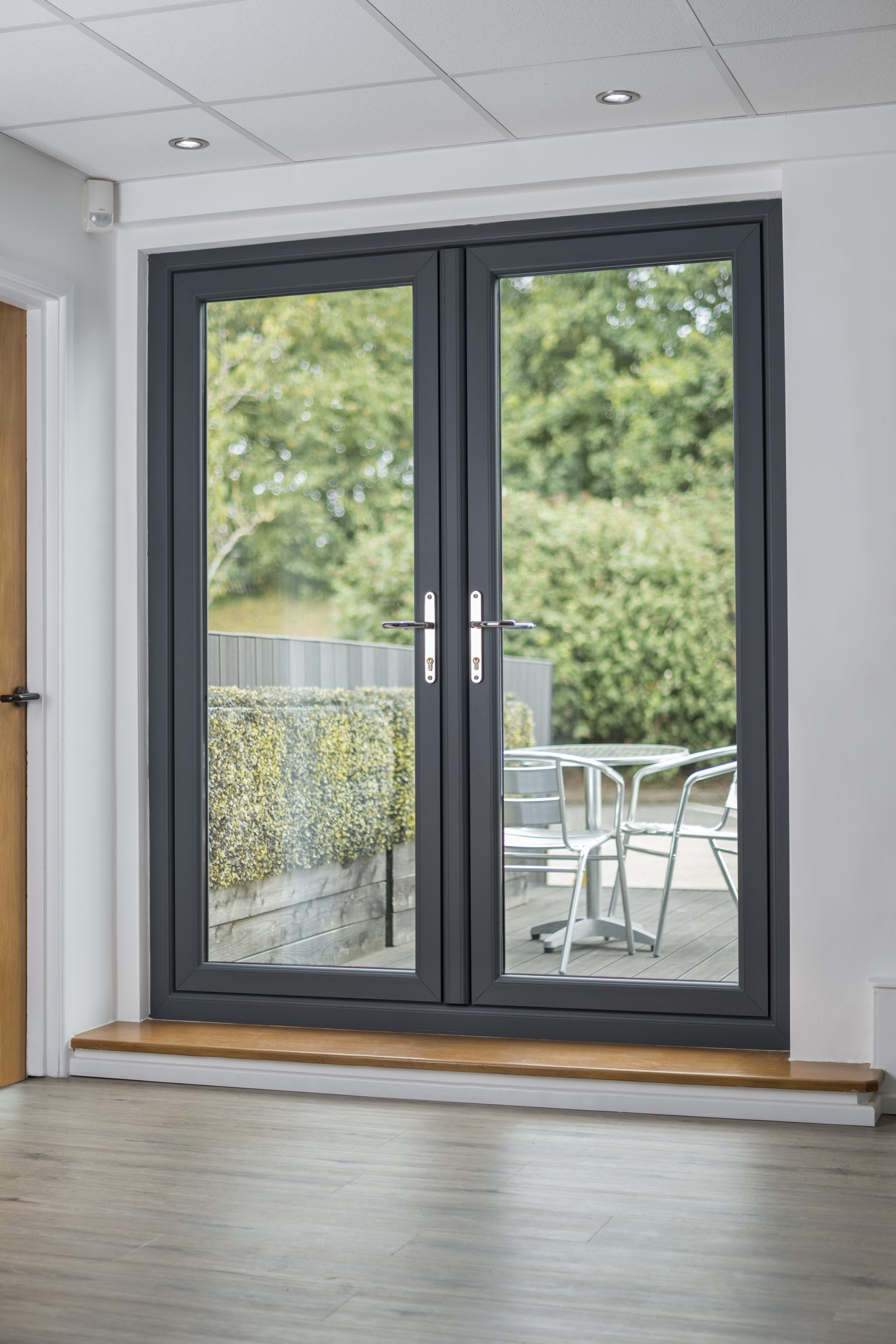 black upvc french door overlooking a garden